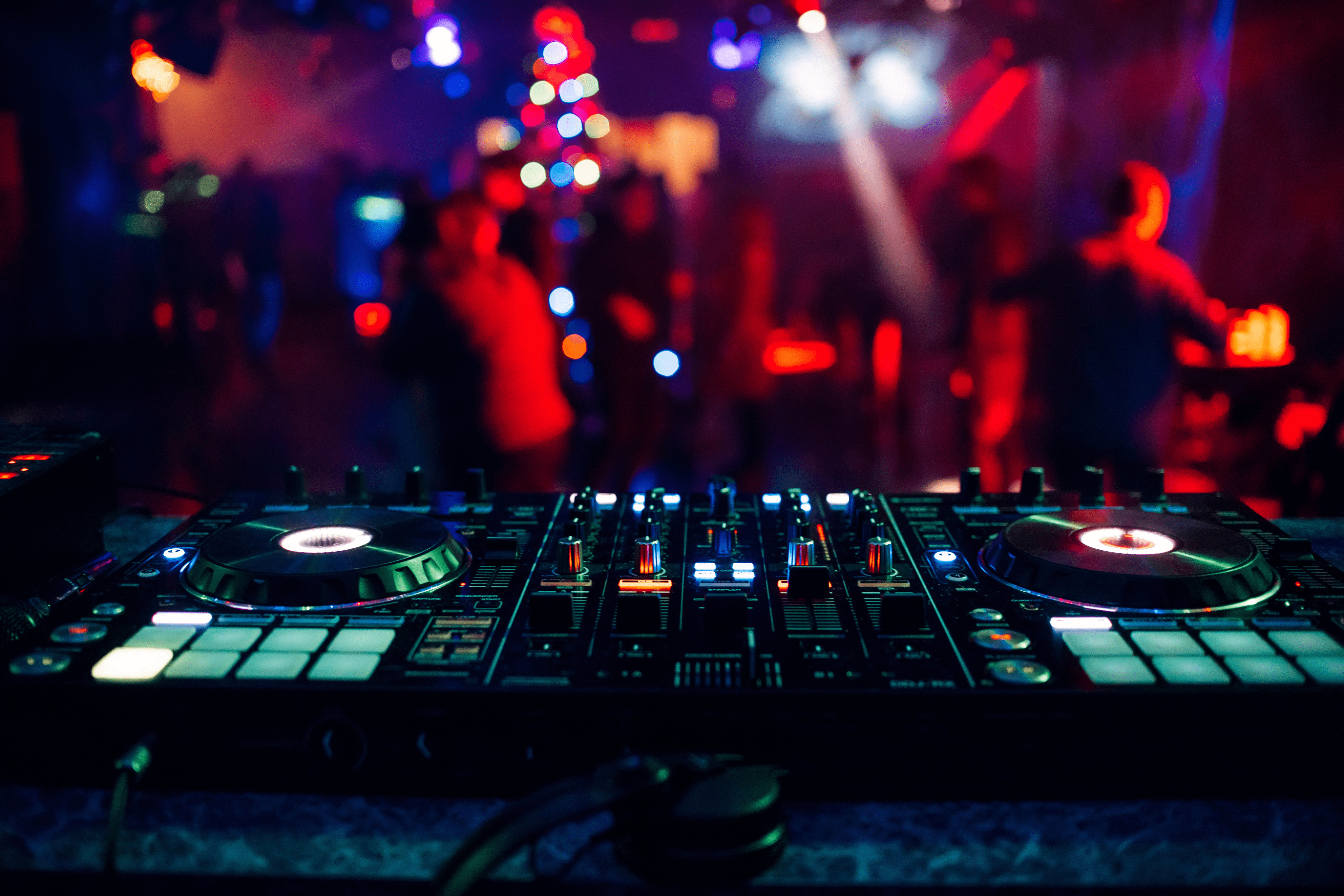 edm dj booth red lights in club